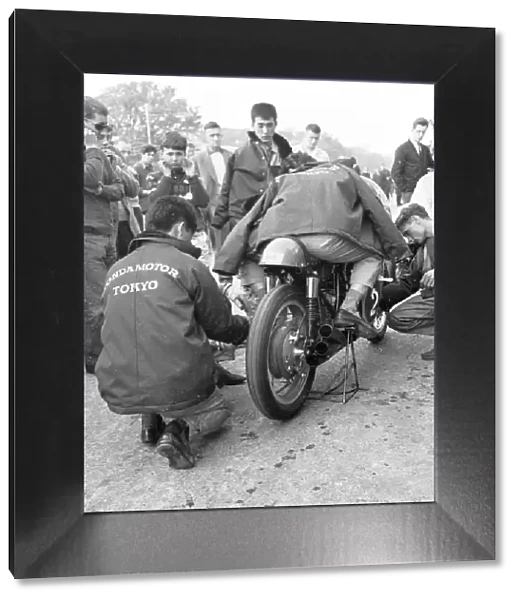 Nobby Clark fettles Jim Redmans Honda 6 1965 Lightweight TT