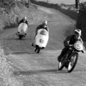 Arthur Wheeler (MV) & Roberto Colombo (MV) & Ken Martin (Anelay) at Signpost Corner, 1956 Ultra Lightweight TT Arthur Wheeler (MV) & Roberto Colombo (MV) & Ken Martin (Anelay) at Signpost Corner, 1956 Ultra Lightweight TT